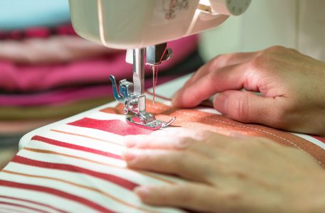 tailor-working-on-sewing-machine-close-up_t20_yRYdgL